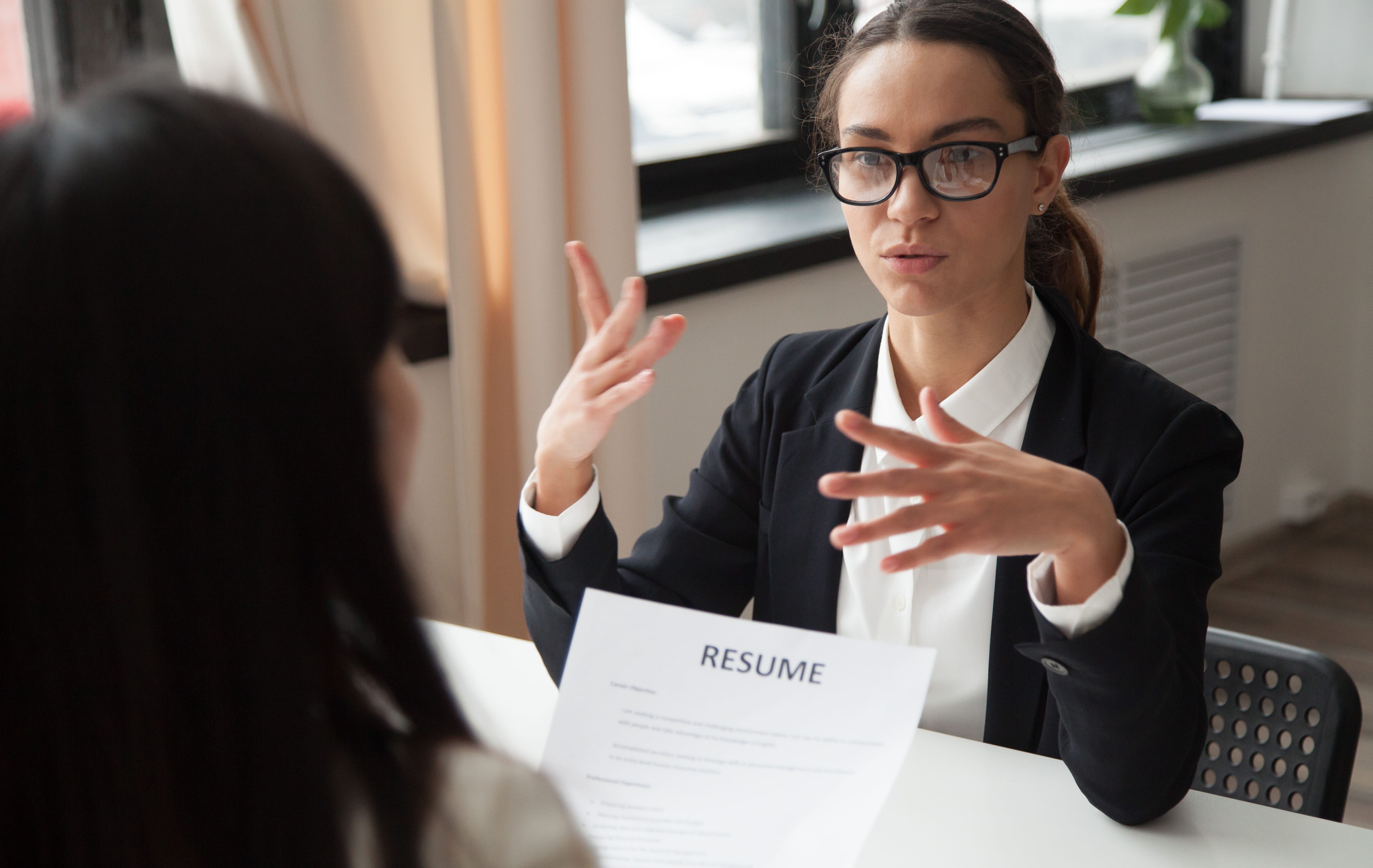 confident-millennial-female-applicant-glasses-talking-job-interview (1) (1) (1).jpg