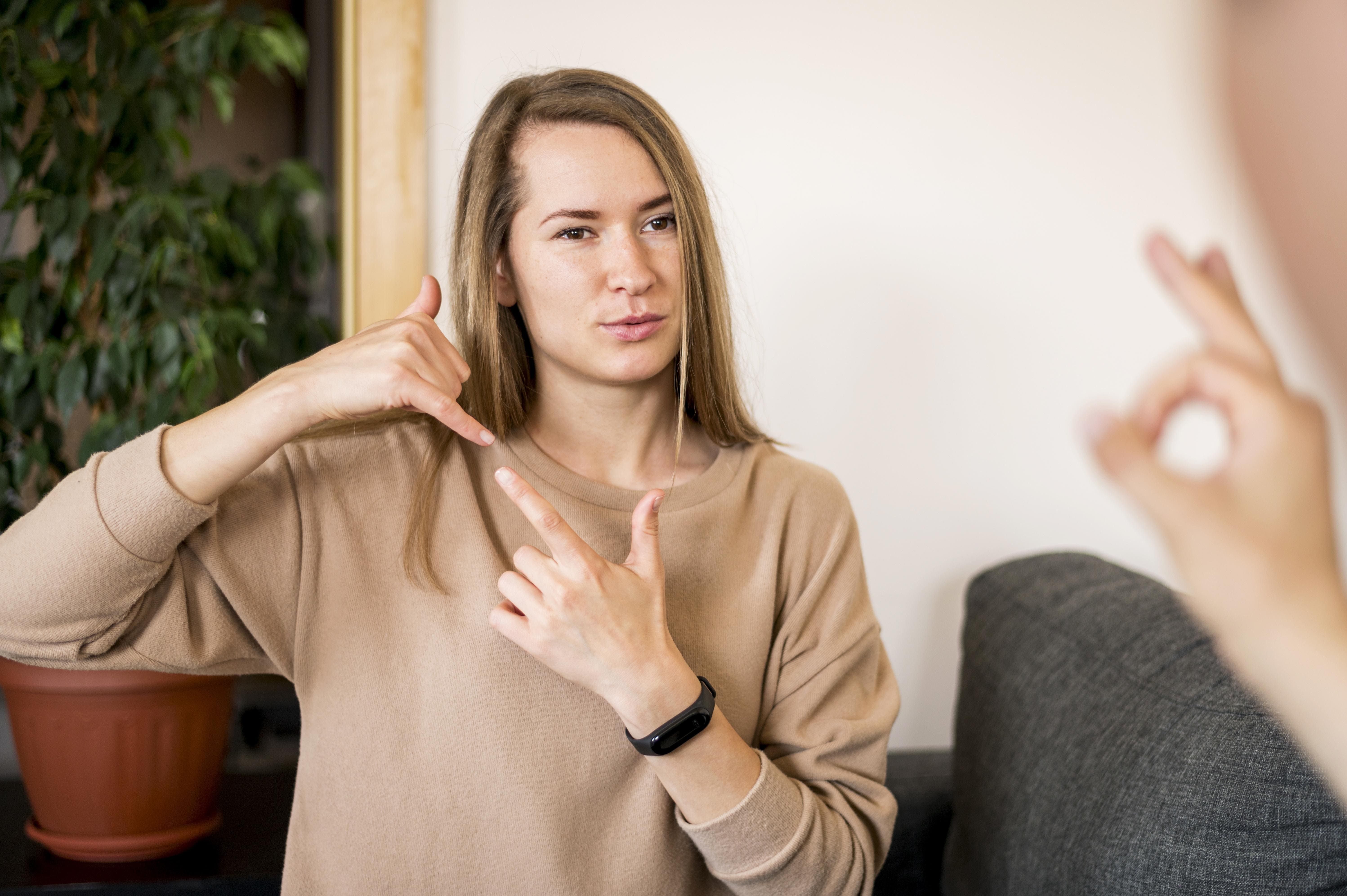 deaf-woman-communicating-through-sign-language (1).jpg